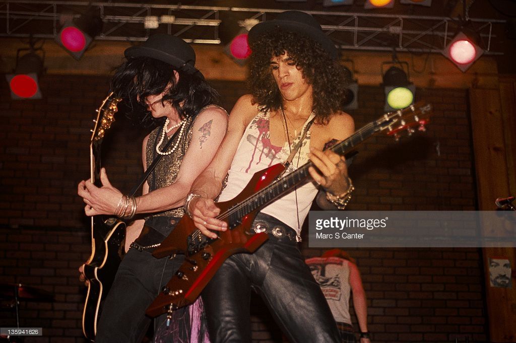 http://i1084.photobucket.com/albums/j414/anoncurappu/coups/Clothes%20Sharing/izzy-stradlin-and-slash-of-the-rock-band-guns-n-roses-perform-onstage-picture-id135941626.jpg